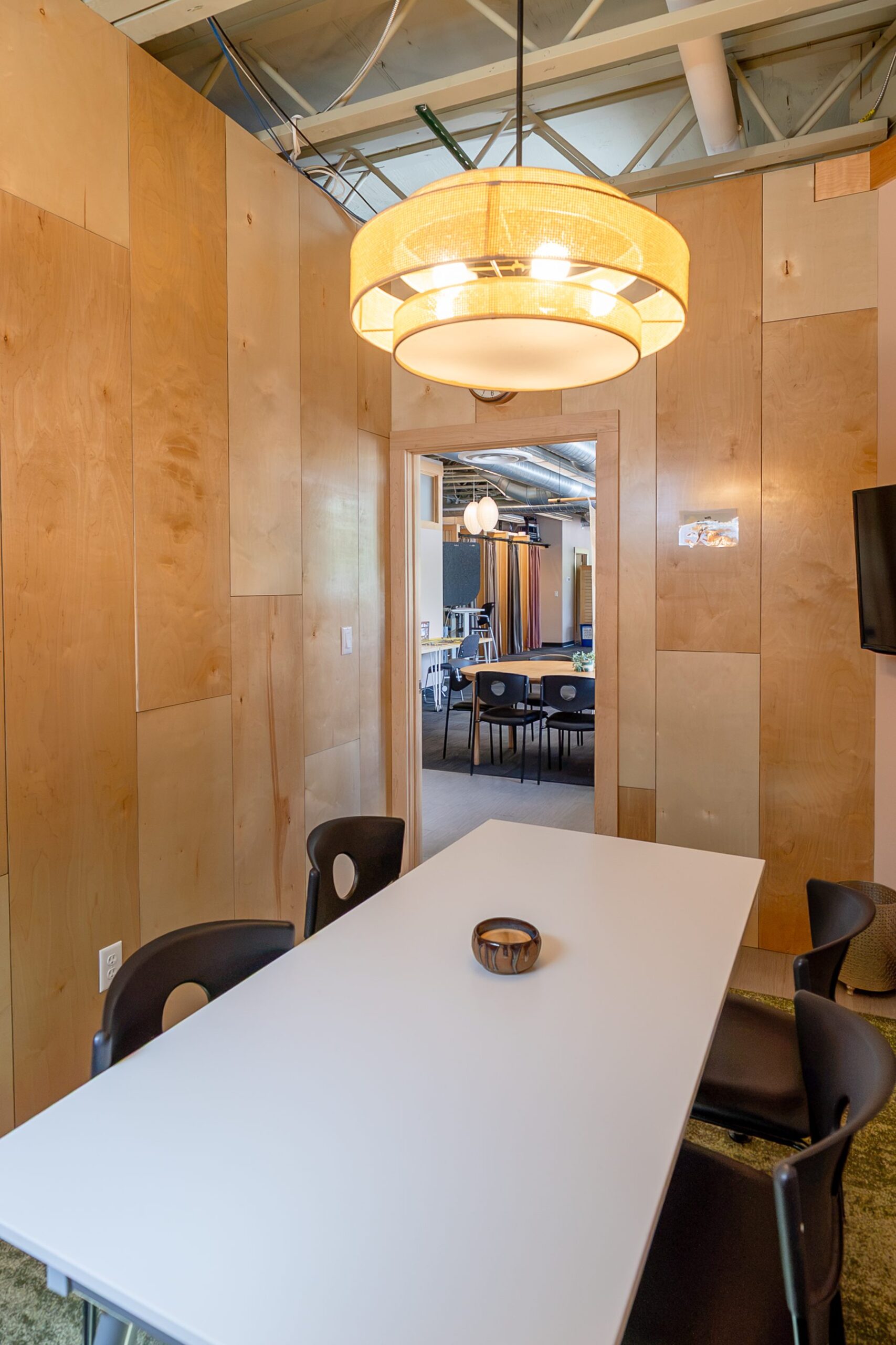 cohere-meeting-room Meeting room with pendant light and white table